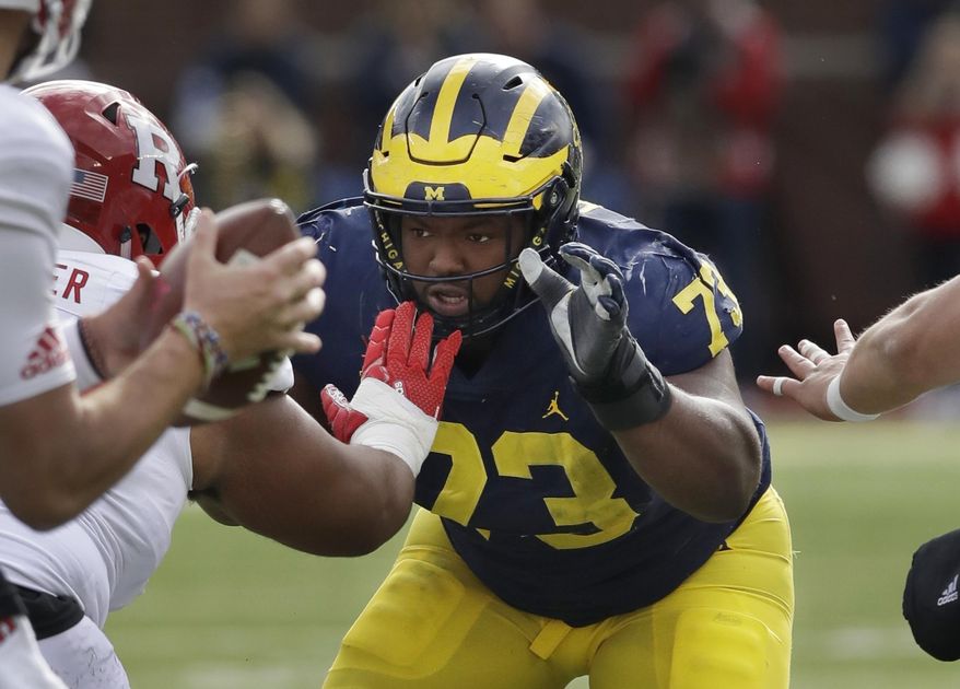 FILE - In this Oct. 28, 2017, file photo, Michigan defensive lineman Maurice Hurst (73) goes up against the Rutgers line during the first half of an NCAA college football game in Ann Arbor, Mich. A person familiar with the situation says Hurst has been given the OK by doctors to participate fully at Michigan's pro day. The person spoke Thursday night, March 22, 2018, to The Associated Press on condition of anonymity because the clearance wasn't announced. Hurst, a potential first-round pick, was held out of drills at the combine three weeks ago after doctors red-flagged a heart condition. (AP Photo/Carlos Osorio, File)