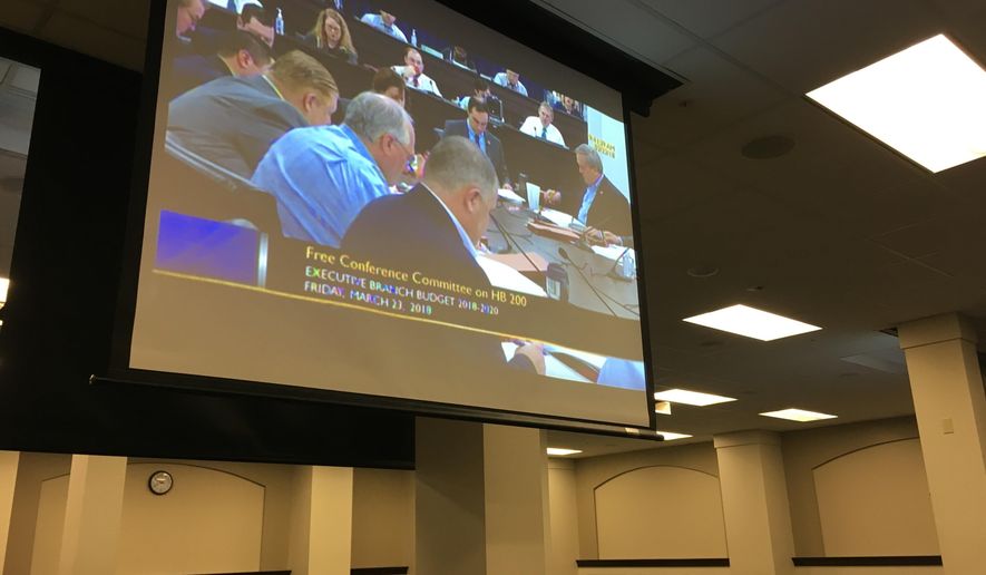 Discussions by Kentucky lawmakers are broadcast Friday, March 23, 2018, in Frankfort, Ky. Media and other members of the public were not allowed into the room as they debated how to spend more than $70 billon of state and federal tax dollars over the next two years (AP Photo/Adam Beam)