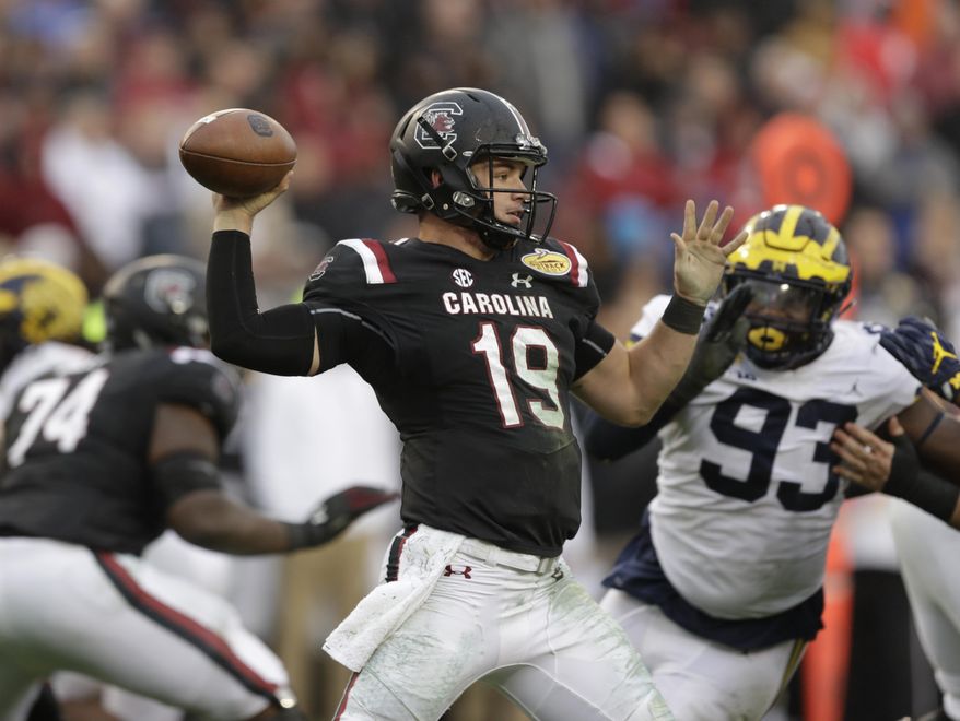 FILE - In this Jan. 1, 2018, file photo, South Carolina quarterback Jake Bentley throws a pass against Michigan during the second half of the Outback Bowl NCAA college football game, in Tampa, Fla. New South Carolina quarterbacks coach Dan Werner was brought on by South Carolina coach Will Muschamp to help ignite an offense that’s been near the bottom of the Southeastern Conference the past two seasons. So far, so good, according to two-year starter Jake Bentley. (AP Photo/Chris O'Meara, File)