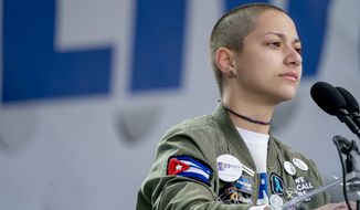 Emma Gonzalez, a survivor of the mass shooting at Marjory Stoneman Douglas High School in Parkland, Fla., closes her eyes and cries as she stands silently at the podium for the amount of time it took the Parkland shooter to go on his killing spree during the &quot;March for Our Lives&quot; rally in support of gun control in Washington, Saturday, March 24, 2018. (AP Photo/Andrew Harnik)