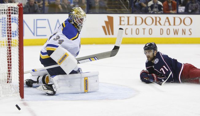 St. Louis Blues&#x27; Jake Allen, left, makes a save against Columbus Blue Jackets&#x27; Nick Foligno during the second period of an NHL hockey game Saturday, March 24, 2018, in Columbus, Ohio. (AP Photo/Jay LaPrete)
