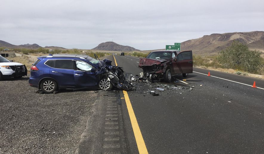 In this photo provided by the Arizona Department of Public Safety, two cars involved in a wrong-way crash that killed three people sit on Interstate 10 near Quartzsite, Ariz., on Saturday, March 24, 2018. The Arizona Department of Public Safety says the wreck occurred when a vehicle used an exit ramp to enter the freeway and then collided with another vehicle about 500 feet (152 meters) from the exit ramp. (Arizona Department of Public Safety via The AP)