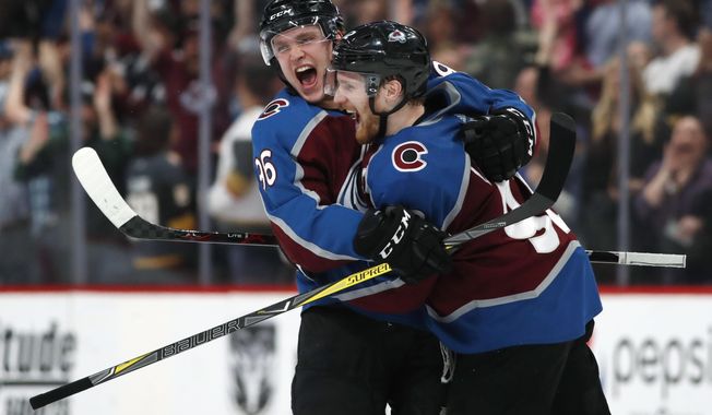 Colorado Avalanche right wing Mikko Rantanen, left, congratulates left wing Gabriel Landeskog after he scored the winning goal against Vegas Golden Knights in the shootout session of an NHL hockey game Saturday, March 24, 2018, in Denver. Colorado won 2-1. (AP Photo/David Zalubowski)