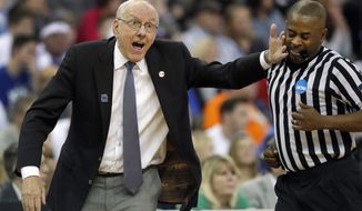 Syracuse head coach Jim Boeheim, left, accidentally hits an official while gesturing on the sideline during the first half of a regional semifinal game against Duke in the NCAA men&#x27;s college basketball tournament Friday, March 23, 2018, in Omaha, Neb. (AP Photo/Charlie Neibergall)