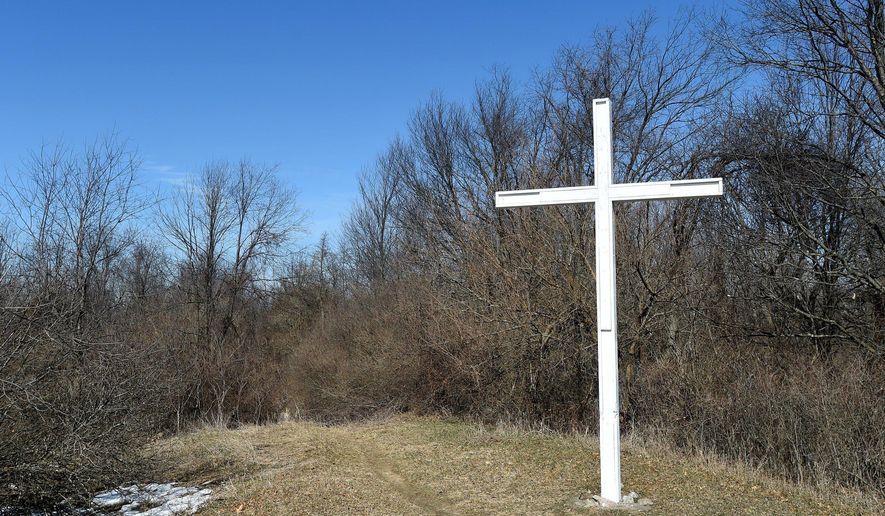 This March 19, 2018 photo shows a cross on Sackrider Hill in the Waterloo Recreation Area near Grass Lake in Jackson, Mich. A Michigan civil rights organization says a large white cross that’s been in Jackson County for nearly 70 years should be removed because it’s on state-owned land. The Michigan Association of Civil Rights Activists has received a complaint from a resident about the cross on Sackrider Hill. The association has requested the state Department of Natural Resources remove the cross since it has clear religious significance. (J. Scott Park/Jackson Citizen Patriot via AP)