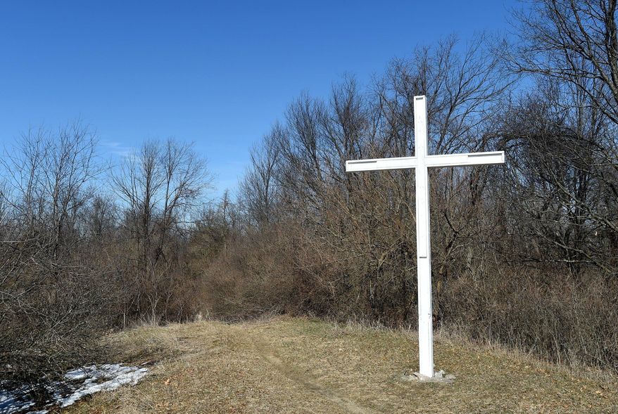 This March 19, 2018 photo shows a cross on Sackrider Hill in the Waterloo Recreation Area near Grass Lake in Jackson, Mich. A Michigan civil rights organization says a large white cross that’s been in Jackson County for nearly 70 years should be removed because it’s on state-owned land. The Michigan Association of Civil Rights Activists has received a complaint from a resident about the cross on Sackrider Hill. The association has requested the state Department of Natural Resources remove the cross since it has clear religious significance. (J. Scott Park/Jackson Citizen Patriot via AP)