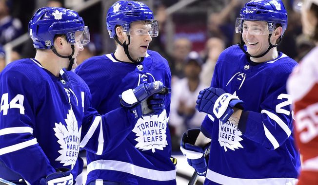 Toronto Maple Leafs winger Connor Brown, center, celebrates his goal against the Detroit Red Wings with teammates Morgan Rielly, left, and Travis Dermott during the second period of an NHL hockey game Saturday, March 24, 2018, in Toronto. (Frank Gunn/The Canadian Press via AP)