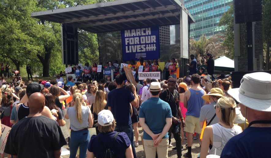 Hundreds of people rally in New Orleans for stricter gun controls on Saturday, March 24, 2018, as part of the March for Our Lives rallies happening across the country. (AP Photo/Rebecca Santana)