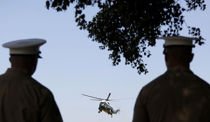 Marines watch as the Marine One helicopter, with President Barack Obama aboard, arrives at Fort McNair, Wednesday, July 4, 2012, in Washington. (AP Photo/Haraz N. Ghanbari)