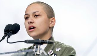 FILE -- In this March 24, 2018 file photo, Emma Gonzalez, a survivor of the mass shooting at Marjory Stoneman Douglas High School in Parkland, Fla., closes her eyes and cries as she stands silently at the podium for the amount of time it took the Parkland shooter to go on his killing spree during the &quot;March for Our Lives&quot; rally in support of gun control in Washington. A doctored photo online appeared to show Gonzalez tearing up the U.S. Constitution. , Saturday, March 24, 2018.  (AP Photo/Andrew Harnik File)