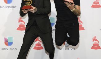 FILE - In this Nov. 19, 2015 file photo, J Balvin, left, poses in the press room with the award for best urban song for &amp;quot;Ay Vamos&amp;quot; and Nicky Jam with the award for best urban performance at the 16th annual Latin Grammy Awards in Las Vegas.  Jam and Balvin&#x27;s latest hit together is &amp;quot;X.&amp;quot; (Photo by Al Powers/Invision/AP, File)