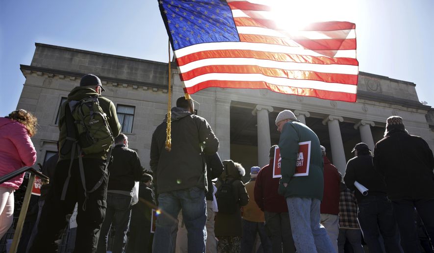 A group of Second Amendment advocates gather in opposition to about a half-dozen gun control bills expected to get a vote in the Assembly on Monday, March 26, 2018, outside the War Memorial near the Statehouse in Trenton, N.J. (AP Photo/Mel Evans)