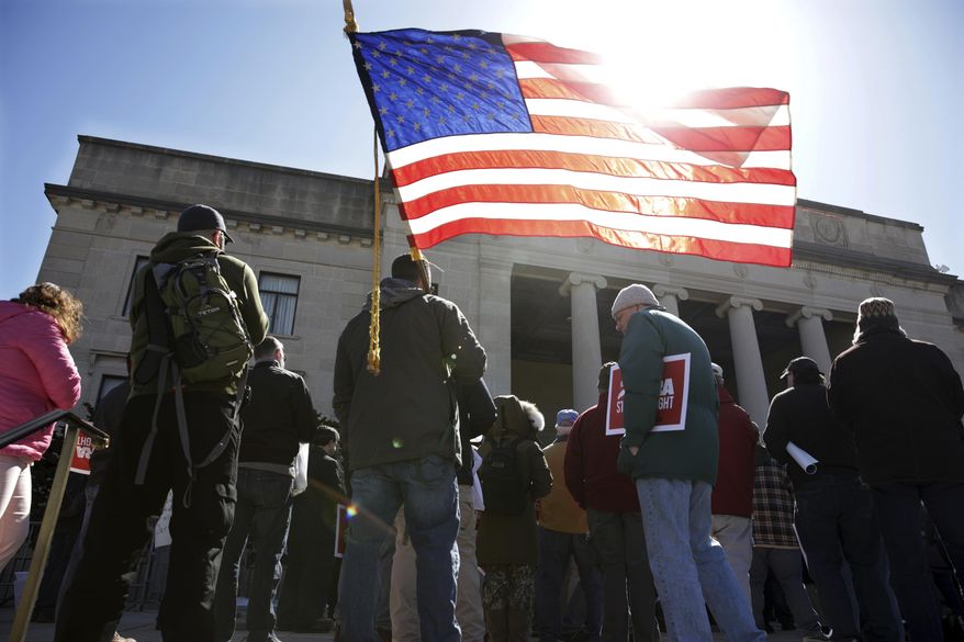 A group of Second Amendment advocates gather in opposition to about a half-dozen gun control bills expected to get a vote in the Assembly on Monday, March 26, 2018, outside the War Memorial near the Statehouse in Trenton, N.J. (AP Photo/Mel Evans)