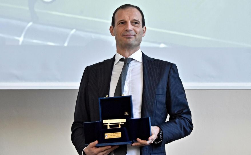 Juventus coach Massimiliano Allegri poses with the golden bench coaching award at the Coverciano's Sports Center, near Florence, Italy, Monday, March 26, 2018. Juventus coach Massimiliano Allegri has won the golden bench coaching award voted by his colleagues for last season. In 2016-17, Allegri guided Juventus to a record sixth straight Serie A title, a third straight Italian Cup championship and the Champions League final. Allegri received 19 votes, Gian Piero Gasperini of Atalanta finished second with 11 votes and Maurizio Sarri of Napoli came third with seven. It's the third time Allegri has won the award. (Maurizio Degl'Innocenti/ANSA via AP)