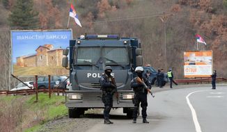 Kosovo police block a road near the northern, Serb-dominated part of Mitrovica, Kosovo, Monday, March 26, 2018. Serbian state television says Kosovo police have arrested one Serb official and fired tear gas and stun grenades at Serb protesters in northern Kosovo. (AP Photo/Bojan Slavkovic)