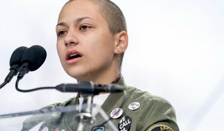 FILE -- In this March 24, 2018 file photo, Emma Gonzalez, a survivor of the mass shooting at Marjory Stoneman Douglas High School in Parkland, Fla., closes her eyes and cries as she stands silently at the podium for the amount of time it took the Parkland shooter to go on his killing spree during the &amp;quot;March for Our Lives&amp;quot; rally in support of gun control in Washington. A doctored photo online appeared to show Gonzalez tearing up the U.S. Constitution. , Saturday, March 24, 2018.  (AP Photo/Andrew Harnik File)