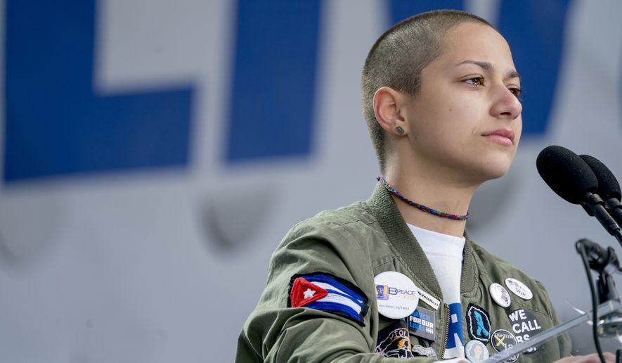 Emma Gonzalez, a survivor of the mass shooting at Marjory Stoneman Douglas High School in Parkland, Fla., closes her eyes and cries as she stands silently at the podium for the amount of time it took the Parkland shooter to go on his killing spree during the "March for Our Lives" rally in support of gun control in Washington, Saturday, March 24, 2018. (AP Photo/Andrew Harnik)