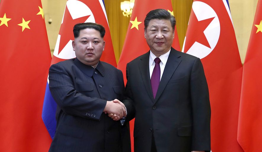 In this photo provided Wednesday, March 28, 2018, by China&#x27;s Xinhua News Agency,  North Korean leader Kim Jong Un, left, and Chinese President Xi Jinping shake hands in Beijing, China. The Chinese government confirmed Wednesday that North Korea&#x27;s reclusive leader Kim went to Beijing and met with Chinese President Xi in his first known trip to a foreign country since he took power in 2011. The official Xinhua News Agency said Kim made an unofficial visit to China from Sunday to Wednesday.(Ju Peng/Xinhua via AP)
