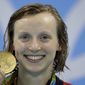 FILE - In this Aug. 9, 2016, file photo, United States&#x27; Katie Ledecky shows off her gold medal during the ceremony for the women&#x27;s 200-meter freestyle final during the swimming competitions at the 2016 Summer Olympics, in Rio de Janeiro, Brazil. Ledecky is turning pro. The five-time Olympic gold medalist announced on Twitter that she is giving up her final two years of eligibility at Stanford, though she will continue to train at the West Coast school as she works toward her degree. (AP Photo/Michael Sohn, File) **FILE**