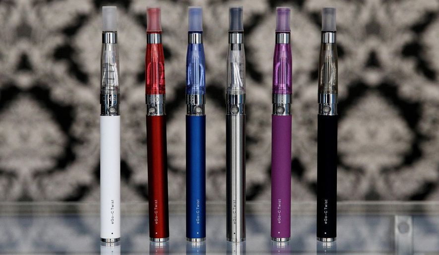 FILE - In this April 23, 2014 file photo, e-cigarettes appear on display at Vape store in Chicago. Several medical and public health groups are suing the Food and Drug Administration over a decision by Trump administration officials to delay the review of e-cigarettes, which they say pose a health threat to U.S. children. (AP Photo/Nam Y. Huh, File)