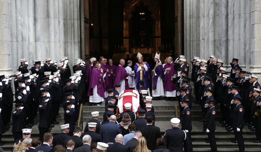 A casket containing the body of firefighter Michael Davidson is brought into St. Patrick&#39;s Cathedral in New York, Tuesday, March 27, 2018. The New York City firefighter died early Friday battling a fierce blaze on a movie set after getting separated from his fellow firefighters in the thick smoke. (AP Photo/Seth Wenig)