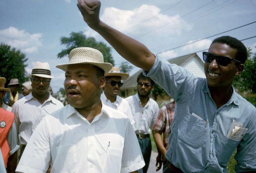 This 1966 image released by HBO shows Dr. Martin Luther King, Jr., left, and Stokely Carmichael in Jackson, Miss., at the Meredith March, used in the documentary, "King in the Wilderness." (Bob Fitch, Stanford University Libraries/HBO via AP)