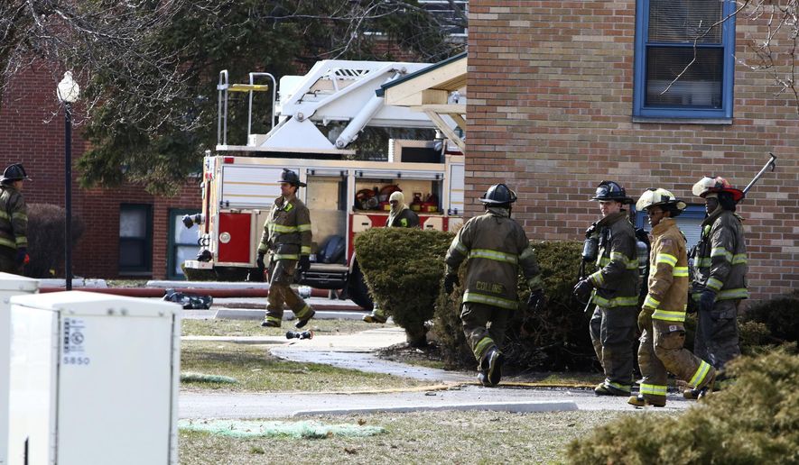 In this Sunday, March 25, 2018 photo, Gary fire and police crews respond to the scene of a deadly fire at the Lakeshore Dunes Apartments in Gary, Ind. The cause is under investigation. (Kale Wilk/The Times via AP)