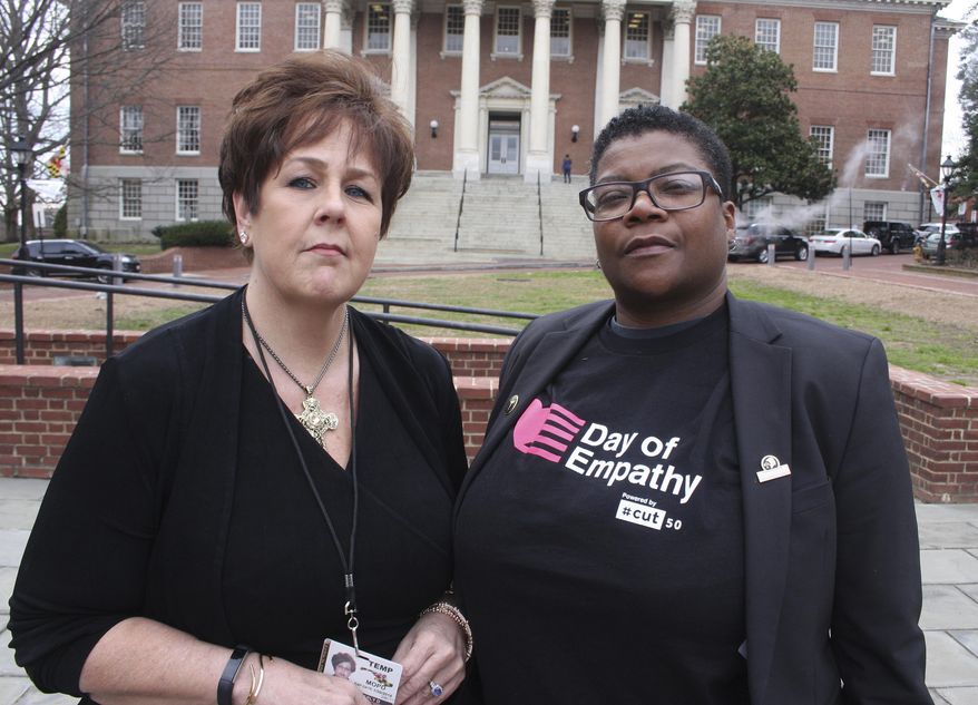 In this March 3, 2018 photo, Kimberly Haven, left, and Monica Cooper, two advocates for reforms in correctional facilities, pose for a photo in front of the Maryland State House in Annapolis, Md. Both Haven and Cooper, who are former inmates, testified in favor of a measure to ensure women have free access to menstrual products on request while in correctional facilities. Growing recognition about the lack of access to basic feminine hygiene products that can occur in correctional facilities has created a wave of measures in state legislatures. (AP Photo/Brian Witte)