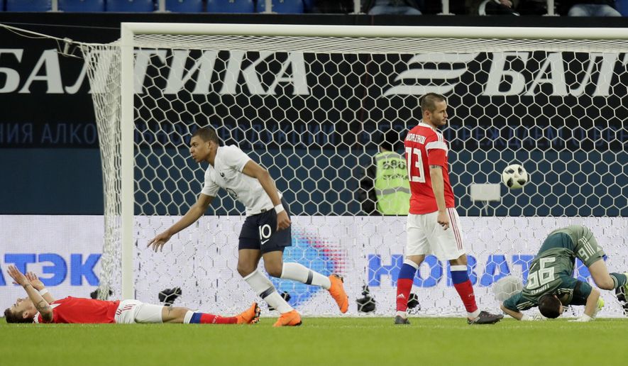 France&#39;s Kylian Mbappe, centre, celebrates scoring the opening goal during the international friendly soccer match between Russia and France at the Saint Petersburg stadium in St.Petersburg, Russia, Tuesday, March 27, 2018. (AP Photo/Dmitri Lovetsky)