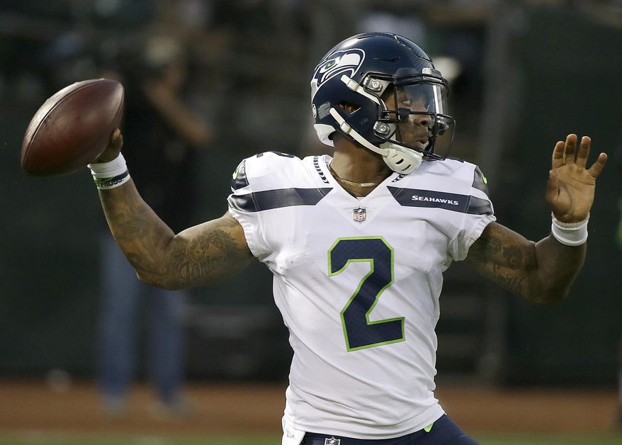 FILE - In this Aug. 31, 2017, file photo, Seattle Seahawks quarterback Trevone Boykin (2) passes against the Oakland Raiders during the first half of an NFL preseason football game in Oakland, Calif. The Seattle Seahawks released quarterback Trevone Boykin shortly after his girlfriend alleged in a television interview that he physically assaulted her in Texas. The practice squad player was released from the team Tuesday, March 27, 2018, after WFAA-TV in Dallas posted an interview with Boykin's girlfriend. She alleges he broke her jaw during an altercation last week in Mansfield, southwest of Dallas. Boykin's agent, Drew Pittman, told the station the allegations are false. Mansfield police told WFAA that Boykin is under investigation. (AP Photo/Eric Risberg, File)
