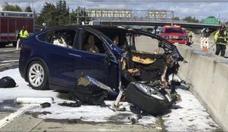 In this Friday March 23, 2018 photo provided by KTVU, emergency personnel work a the scene where a Tesla electric SUV crashed into a barrier on U.S. Highway 101 in Mountain View, Calif. The National Transportation Safety Board has sent two investigators to look into a fatal crash and fire Friday in California that involved a Tesla electric SUV. The agency says on Twitter that it&#39;s not clear whether the Tesla Model X was operating on its semi-autonomous control system called Autopilot at the time. Investigators will study the fire that broke out after the crash. (KTVU via AP)