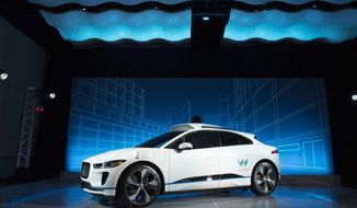 The Jaguar I-Pace vehicle is introduced Tuesday, March 27, 2018, in New York. Self-driving car pioneer Waymo will buy up to 20,000 of the electric vehicles from Jaguar Land Rover to help realize its vision for a robotic ride-hailing service. The commitment announced Tuesday marks another step in Waymo&#x27;s evolution from a secret project started in Google nine years ago to a spin-off that&#x27;s gearing up for an audacious attempt to reshape the transportation business. (AP Photo/Mark Lennihan)