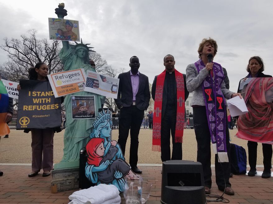 The Rev. Sharon Stanley (right center) speaks with a group of Christian leaders and immigration activists in front of the White House on Wednesday to protest the decreasing number of refugees admitted into the United States under the Trump administration. (Julia Airey/The Washington Times)