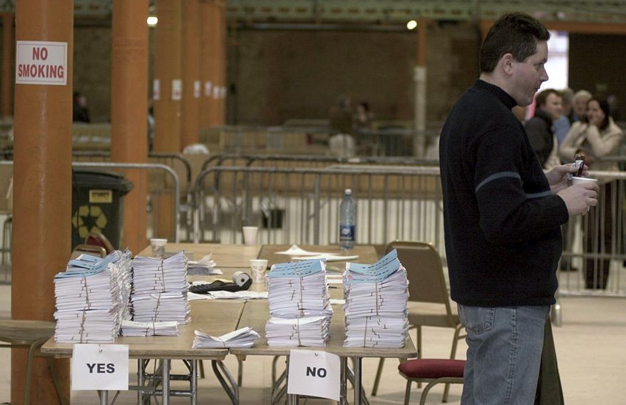 FILE - In this Thursday, March 7, 2002 file photo, officials take a break during the counting of votes in central Dublin as the Irish government concedes defeat in the referendum on the amendment to the abortion law by 49.5% to 50.43%. Ireland will hold a referendum on May 25, 2018 on whether to lift a constitutional ban on most abortions. Voters will be asked whether they want to retain the eighth amendment to Ireland's constitution, which greatly limits abortion, or repeal it and make parliament responsible for making abortion laws. (AP Photo/John Cogill, file)
