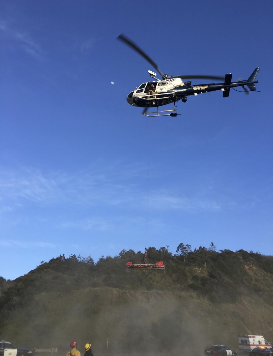This Tuesday, March 27, 2018, photo provided by the California Highway Patrol shows a helicopter hovering over the scene where a vehicle plunged off a cliff in Northern California near Mendocino, Calif. The California Highway Patrol identified the adult victims Wednesday as Jennifer Hart and Sarah Hart, who died along with a few other children. (California Highway Patrol via AP)
