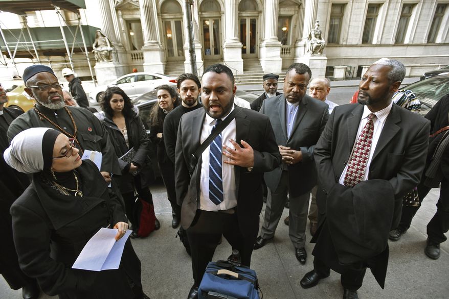 FILE - In this March 8, 2016 file photo, Samir Hashmi, center, and community leaders hold a news conference in New York after oral arguments heard in court in a lawsuit by Hashmi challenging the New York Police Department's use of a Cold War-era legal tactic to conceal whether it put Hashmi and another Muslim man under surveillance. The state's highest court ruled Thursday, March 29, 2018 that the NYPD was within its rights to "neither confirm nor deny" the records pertaining to possible surveillance of Talib Abdur-Rashid, a Manhattan imam, and Hashmi, a former Rutgers University student even existed. (Viorel Florescu/The Record of Bergen County via AP, File)
