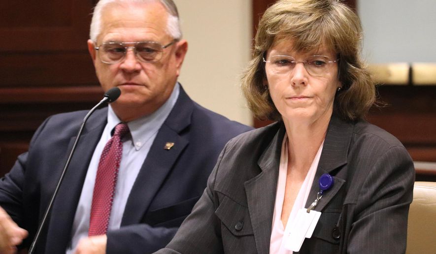 FILE - In a Wednesday, Oct. 11, 2017 file photo, Arkansas Department of Correction Director Wendy Kelley, right, testifies before legislators at the state Capitol complex in Little Rock with deputy director Dale Reed at her side. The Arkansas Supreme Court ruled Thursday, March 29, 2018, that Kelley’s agency must identify the companies that manufacture Arkansas’ execution drugs but that information that identifies the middlemen can be withheld. (AP Photo/Kelly P. Kissel, File)