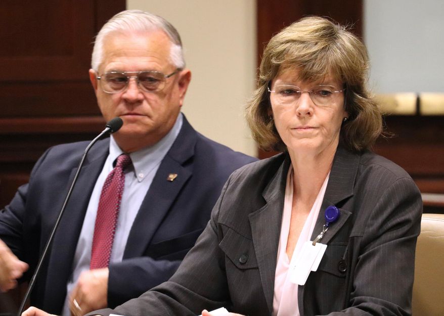 FILE - In a Wednesday, Oct. 11, 2017 file photo, Arkansas Department of Correction Director Wendy Kelley, right, testifies before legislators at the state Capitol complex in Little Rock with deputy director Dale Reed at her side. The Arkansas Supreme Court ruled Thursday, March 29, 2018, that Kelley’s agency must identify the companies that manufacture Arkansas’ execution drugs but that information that identifies the middlemen can be withheld. (AP Photo/Kelly P. Kissel, File)