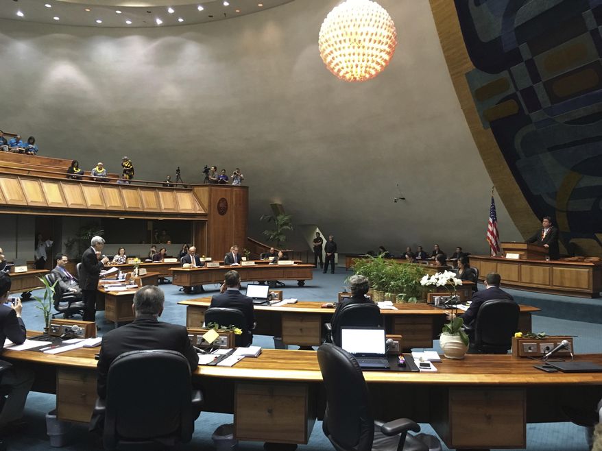 State Sen. Breene Harimoto, who is battling cancer, stands on the floor of the Hawaii Senate to voice his opposition to a medically assisted suicide bill in Honolulu on Thursday, March 29, 2018. Hawaii lawmakers have approved legislation that would make it the latest liberal-leaning state to legalize medically assisted suicide. (AP Photo/Audrey McAvoy)