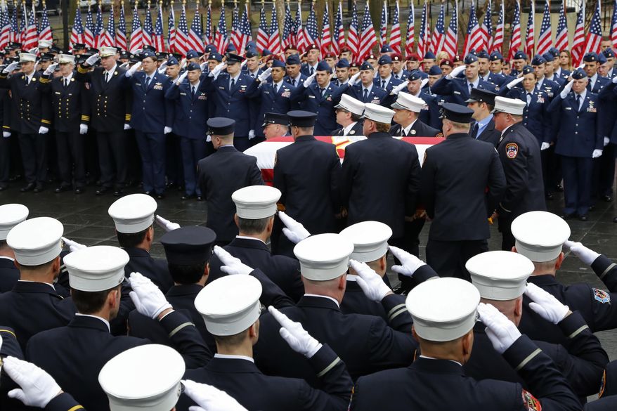 Firefighters salute as the casket for firefighter Capt. Christopher T. Zanetis is carried during a memorial ceremony held in New York's Washington Square Park, Thursday, March 29, 2018. He was one of seven servicemen who were killed when their Air Force helicopter crashed in Anbar province in western Iraq. He was a member of the New York Air National Guard's 106th Rescue Wing, based at F.S. Gabreski Air National Guard Base in Westhampton Beach on Long Island. (AP Photo/Mark Lennihan)