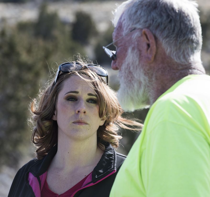 Amanda Hunt, aunt of missing teen Breezy Otteson, waits with Bill Powell, adoptive father of missing teen Riley Powell, as crews work to recover the two bodies that were found in an abandoned mine in Utah's west desert near Eureka, Utah on Wednesday March, 28, 2018. (Rick Egan/The Salt Lake Tribune via AP)