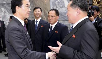 South Korean Unification Minister Cho Myoung-gyon, left, shakes hands with North Korean delegation head Ri Son Gwon after their meeting at the northern side of the Panmunjom Thursday, March 29, 2018. North Korean leader Kim Jong Un will meet South Korean President Moon Jae-in at a border village on April 27, the South announced Thursday after the nations agreed on a rare summit that could prove significant in global efforts to resolve a decades-long standoff over the North&#x27;s nuclear program. (Korea Pool Photo via AP)