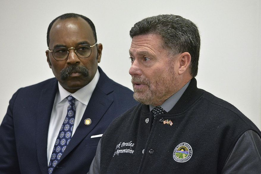 In this Nov. 17, 2017, photo, Republican Rick Perales, R-Beavercreek, right, and State Reps. Hearcel F. Craig, D-Columbus, left, tour Wright-Patterson Air Force Base, near Dayton, Ohio. A woman with whom Perales exchanged sexual text messages has launched a campaign to unseat him and threatened to release more details about their relationship if he doesn't resign. (Jim Otte/WHIO-TV via AP)