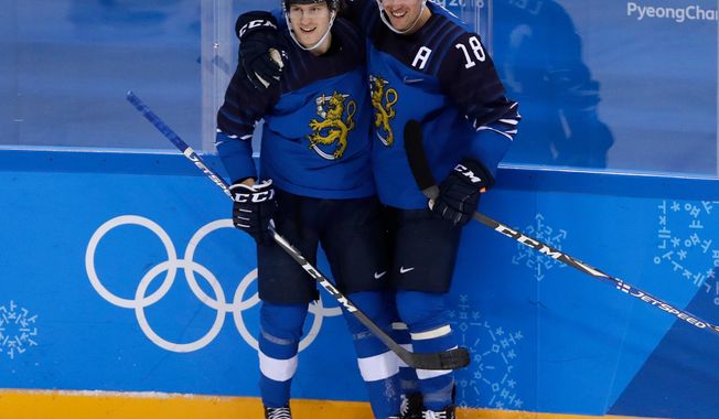 FILE - In this Feb. 16, 2018, file photo, Eeli Tolvanen, of Finland, left, celebrates a goal with Sami Lepisto (18) during the second period of the preliminary round of the men&#x27;s hockey game against Norway at the 2018 Winter Olympics in Gangneung, South Korea.  The Nashville Predators have signed forward Eeli Tolvanen of Finland, the 30th pick overall last year, to an entry-level contract, adding the talented 18-year-old to a roster already sitting atop the NHL. General manager David Poile announced Thursday, March 29, 2018, that the immigration and other paperwork had been completed with Tolvanen agent Jay Grossman in Nashville to finalize the last details.  (AP Photo/Frank Franklin II, File)