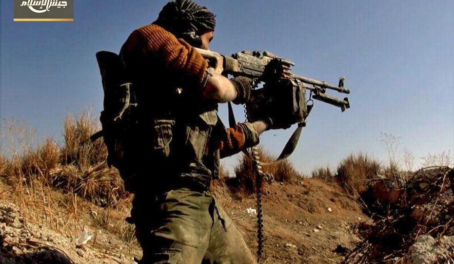 This photo provided Feb. 2, 2018, by the Syrian rebel group Army of Islam, shows a fighter with the Army of Islam rebel group, firing his weapon during clashes with government forces in Housh al-Dhawahira in the eastern Ghouta region near Damascus, Syria. In the spring of 2015, the Army of Islam rebel group held a massive military parade that included thousands of opposition fighters marching in formation and a striking display of tanks and armored vehicles in the town of Douma, at the doors of the Syrian capital. Now, the Army of Islam stands alone in eastern Ghouta, its fighters facing a stark choice: Surrender or die. (Army of Islam, via AP)