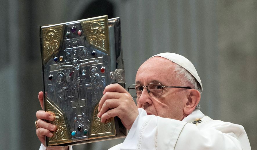 Pope Francis holds up the Gospel as he celebrates a Chrism Mass inside St. Peter&#39;s Basilica, at the Vatican, Thursday, March 29, 2018. Francis urged priests on Thursday to be spiritually close to their flocks and not insist on preaching only laws when they sin. (Vatican Media via AP)