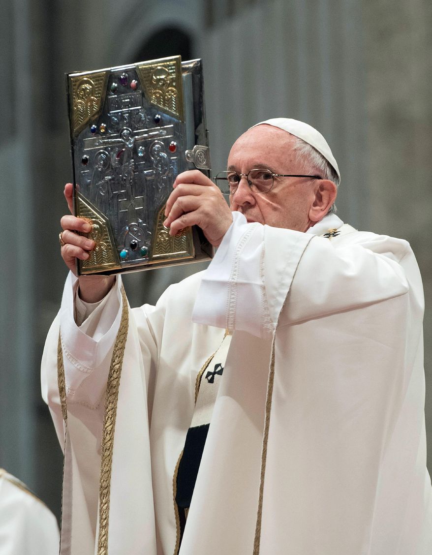 Pope Francis holds up the Gospel as he celebrates a Chrism Mass inside St. Peter&#39;s Basilica, at the Vatican, Thursday, March 29, 2018. Francis urged priests on Thursday to be spiritually close to their flocks and not insist on preaching only laws when they sin. (Vatican Media via AP)