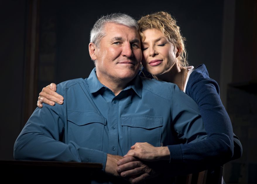 In this Monday March 26, 2018 photo, former Super Bowl MVP and Shadle Park High graduate Mark Rypien poses with his wife Danielle, in Spokane, Wash. With the help of his wife Rypien is dealing with a traumatic brain injury caused by the many concussions he received during his football career. (Colin Mulvany /The Spokesman-Review via AP)