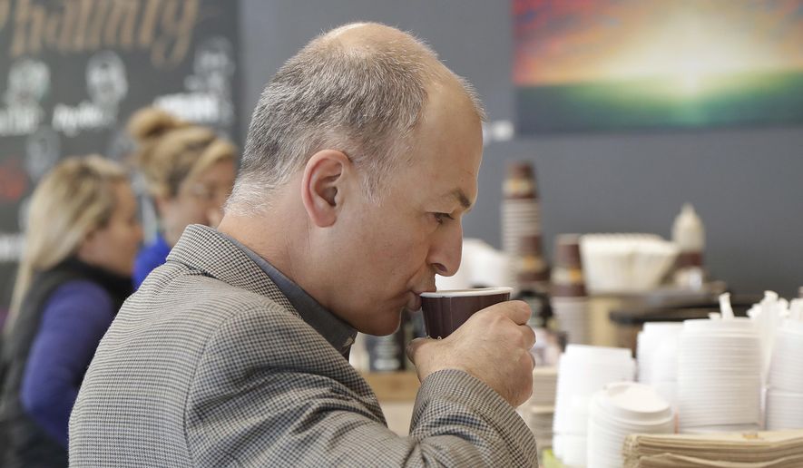 Afshin Afshar takes a sip from a coffee drink he bought at a Philz Coffee shop in San Francisco, Friday, March 30, 2018. Coffee sellers will have to post ominous warnings in California because each cup contains a chemical linked to cancer, a judge ruled. The culprit is a byproduct of the bean roasting process that is a known carcinogen and has been at the heart of an eight-year legal struggle between a tiny nonprofit group and Big Coffee companies. (AP Photo/Jeff Chiu) ** FILE **