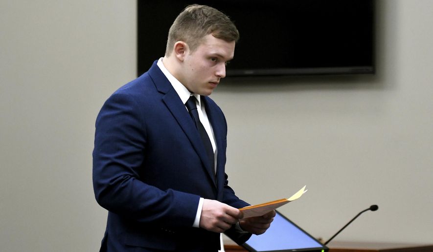 In this Thursday, March 29, 2018 photo, Damian Walker leaves court during a pretrial hearing in Ingham County Circuit Court, in Lansing, Mich. Walker, charged following a threat that prompted Lansing Community College to evacuate in November, pleaded guilty to making a false report or threat of terrorism. (Nick King/Lansing State Journal via AP)